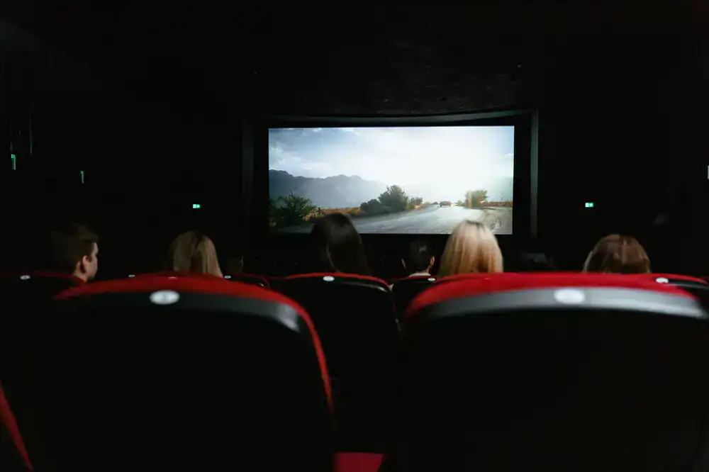 Students reviewing a finished game prototype on a large screen