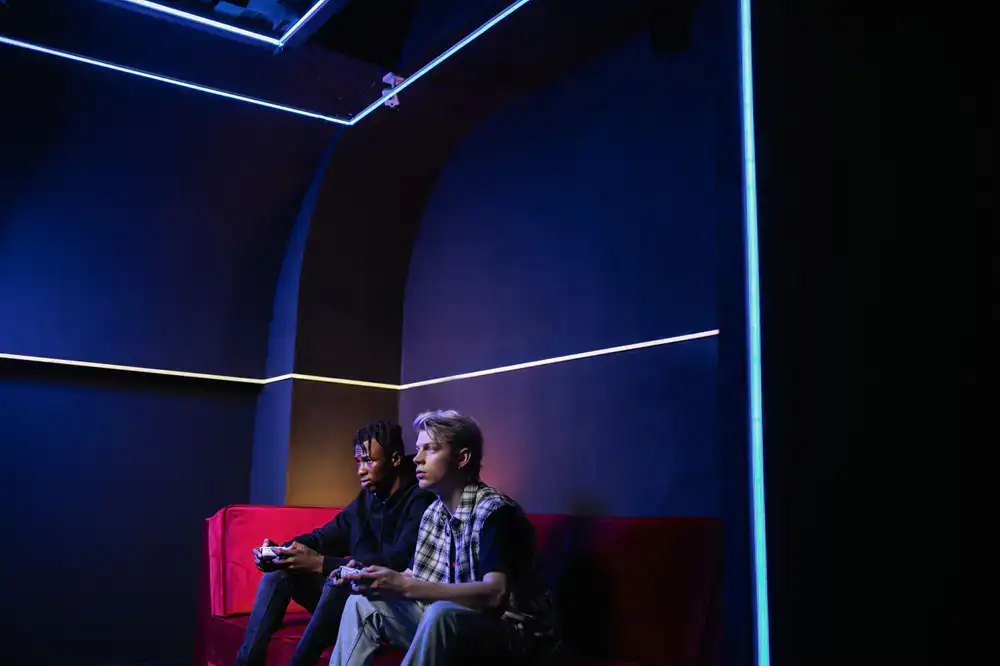 Two students testing a game with controllers